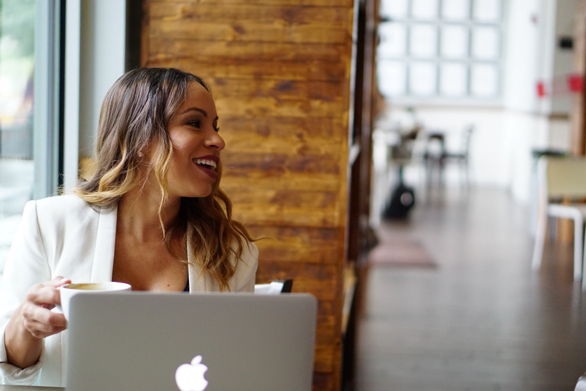 Latina woman on laptop smiling