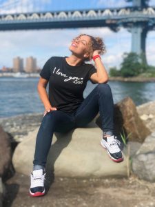 Latina woman with black shirt that says I love God