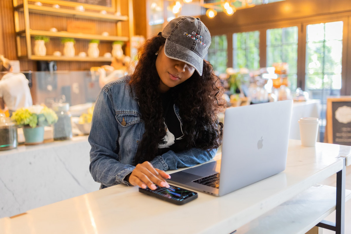 woman with laptop and cell phone