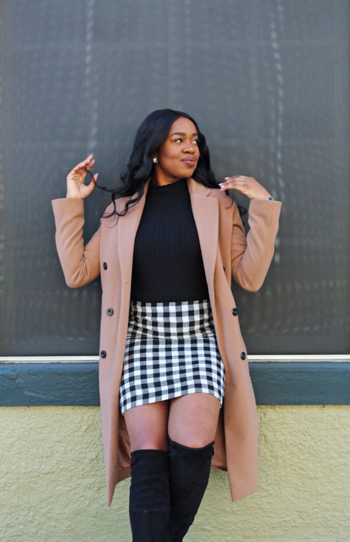 woman in black and white checked mini skirt and brown coat