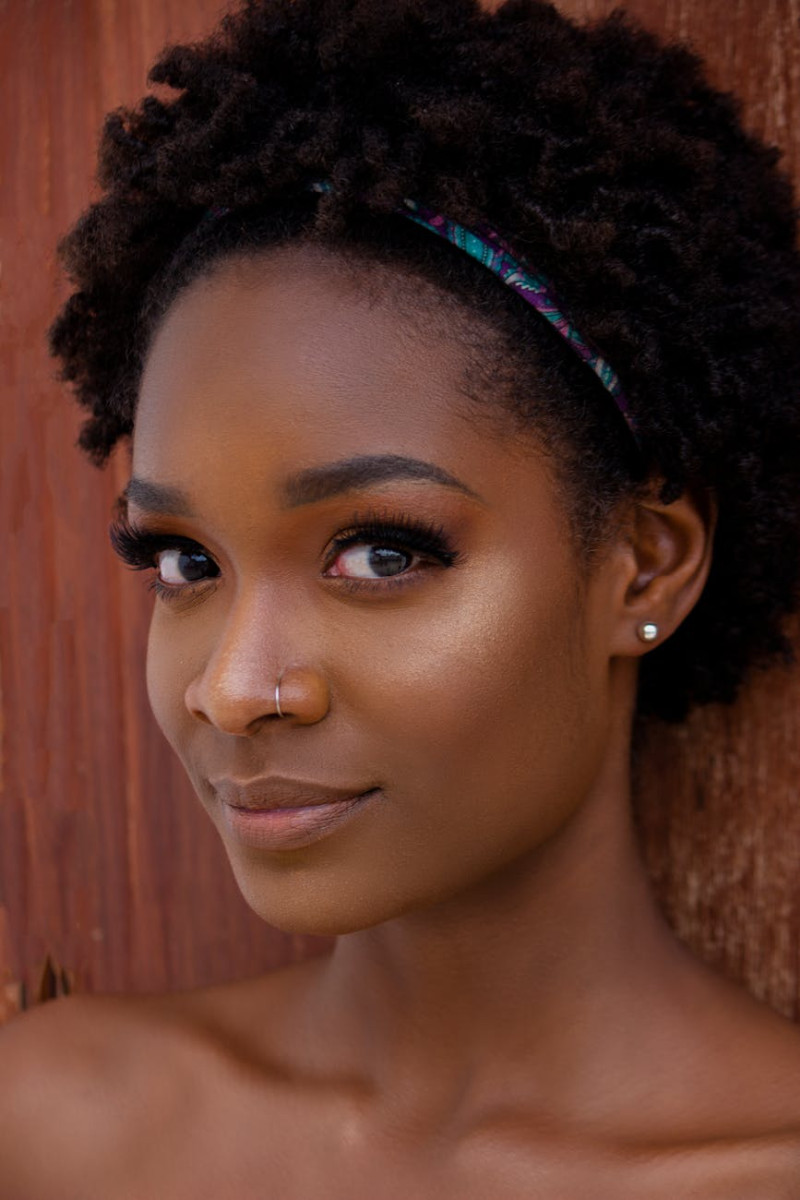portrait of woman wearing headband exuding feminine energy